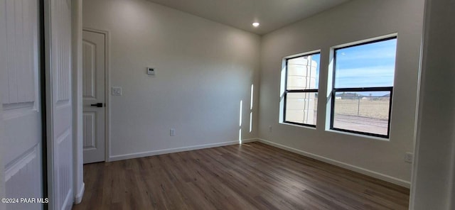 empty room featuring dark wood-type flooring