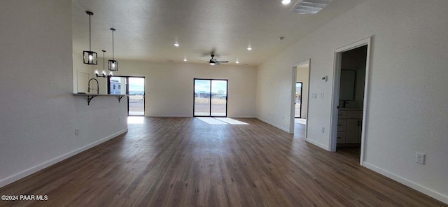 unfurnished living room with dark hardwood / wood-style flooring and ceiling fan
