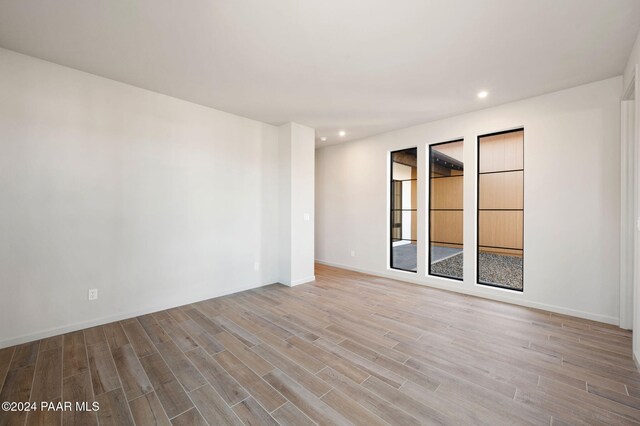 spare room with hardwood / wood-style flooring