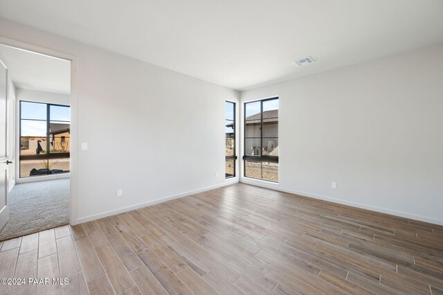 unfurnished room featuring light hardwood / wood-style floors