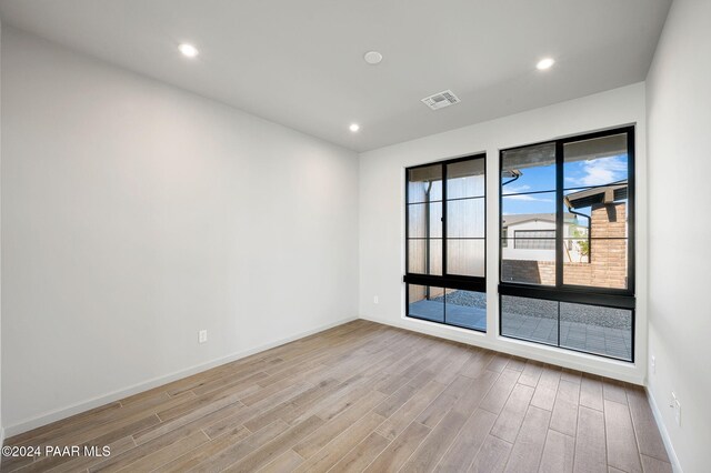 unfurnished room featuring light hardwood / wood-style floors