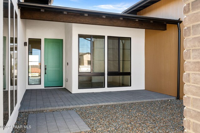 doorway to property featuring a patio area