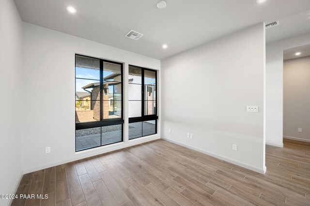 spare room featuring light hardwood / wood-style floors