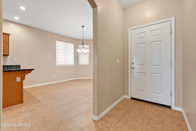 foyer entrance featuring a notable chandelier