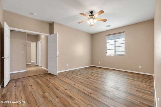 unfurnished room with ceiling fan and light hardwood / wood-style floors