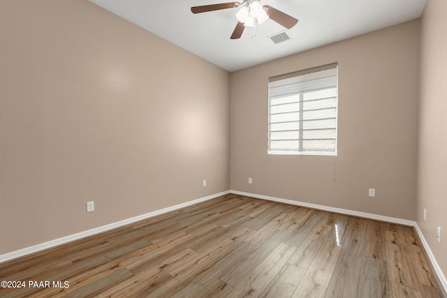 empty room with light hardwood / wood-style flooring and ceiling fan