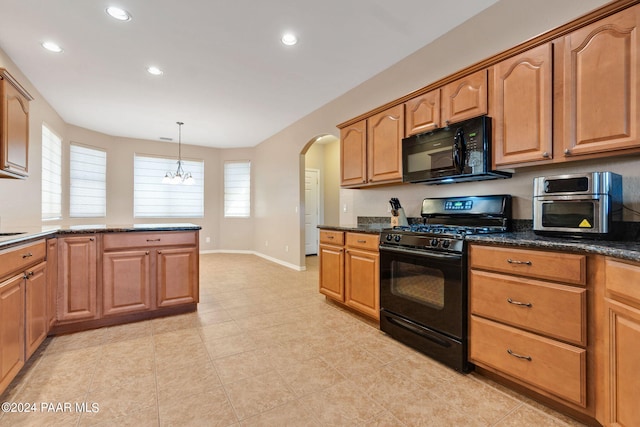 kitchen with dark stone countertops, pendant lighting, and black appliances