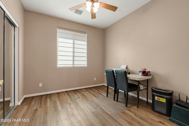 home office featuring light wood-type flooring and ceiling fan