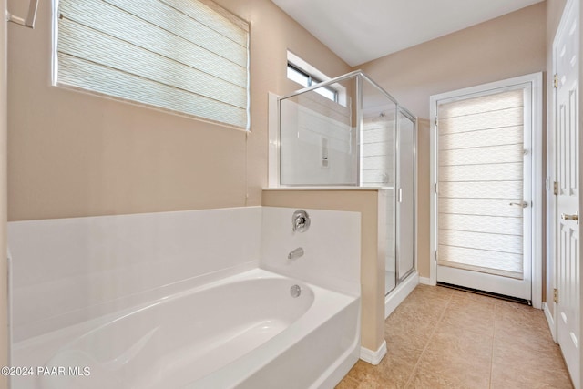 bathroom featuring plus walk in shower and tile patterned floors