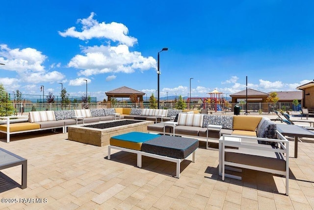 view of patio with a gazebo, outdoor lounge area, and fence