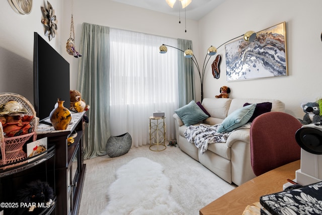 living room with carpet flooring and a ceiling fan