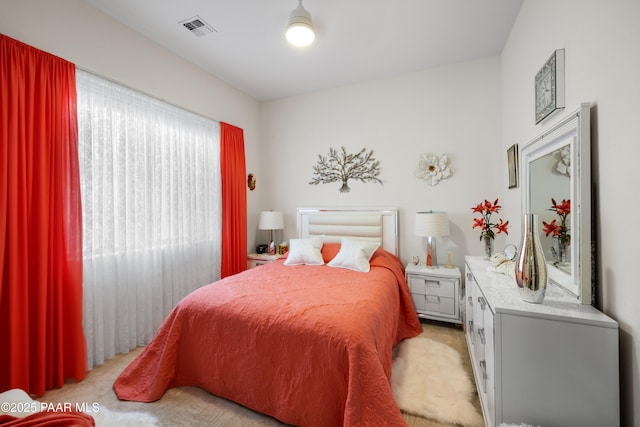 bedroom with visible vents and light colored carpet