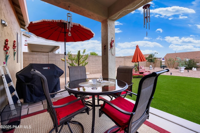 view of patio / terrace with a grill, outdoor dining area, and a fenced backyard