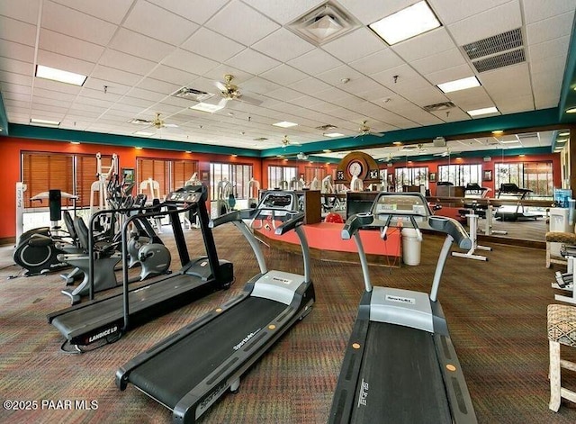 gym featuring visible vents, a paneled ceiling, and ceiling fan