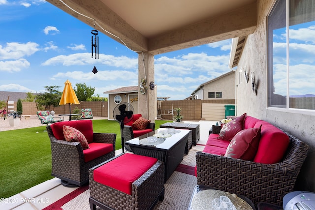 view of patio featuring an outdoor hangout area, an outbuilding, a fenced backyard, and outdoor dining space