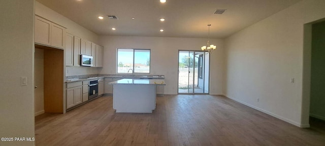 2535 Dillon Blvd, Chino Valley, AZ 86323 - kitchen with stainless steel appliances, a center island, light countertops, a chandelier, and recessed lighting