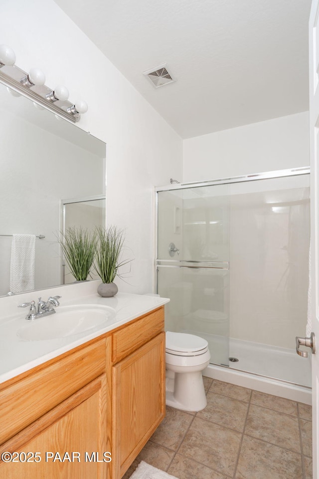 bathroom featuring toilet, vanity, and walk in shower