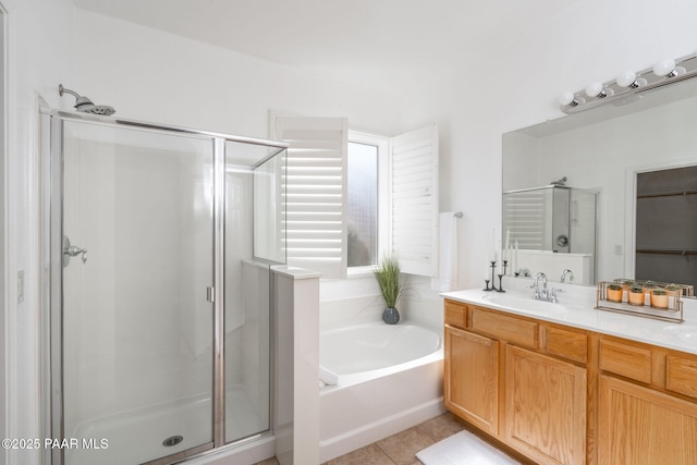 bathroom featuring independent shower and bath, vanity, and tile patterned floors