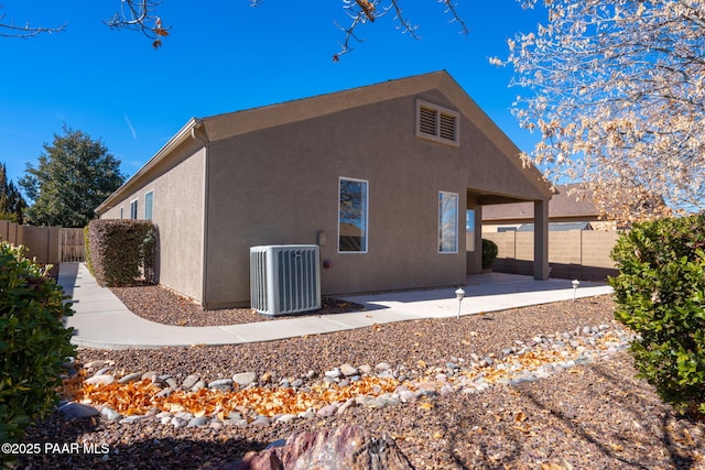 rear view of house featuring a patio and central air condition unit