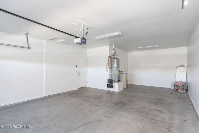 garage with a garage door opener and gas water heater