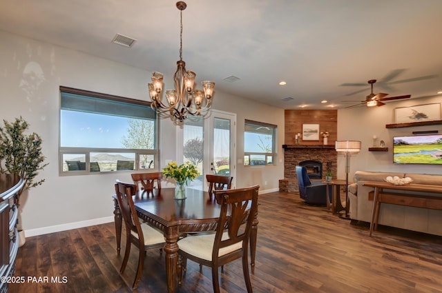 9150 N Whitney Way, Prescott Valley, AZ 86315 - dining space featuring a fireplace, dark wood finished floors, a chandelier, baseboards, and ceiling fan