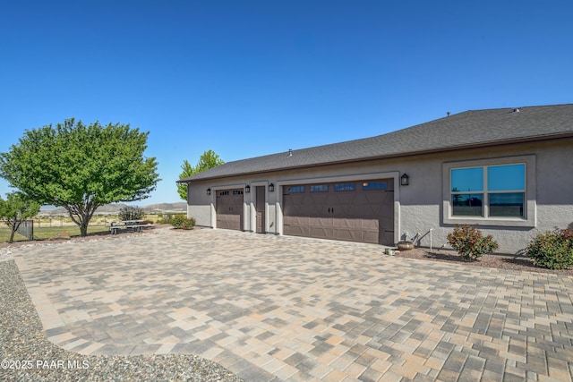 9150 N Whitney Way, Prescott Valley, AZ 86315 - view of front of home with stucco siding, an attached garage, driveway, and fence