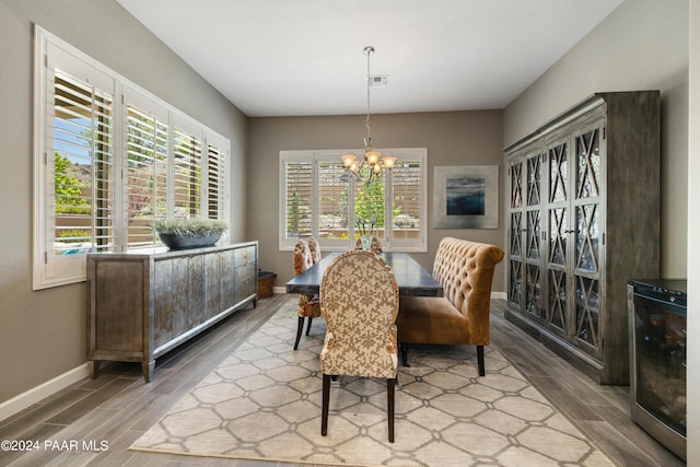 dining room featuring a wealth of natural light, hardwood / wood-style floors, and an inviting chandelier