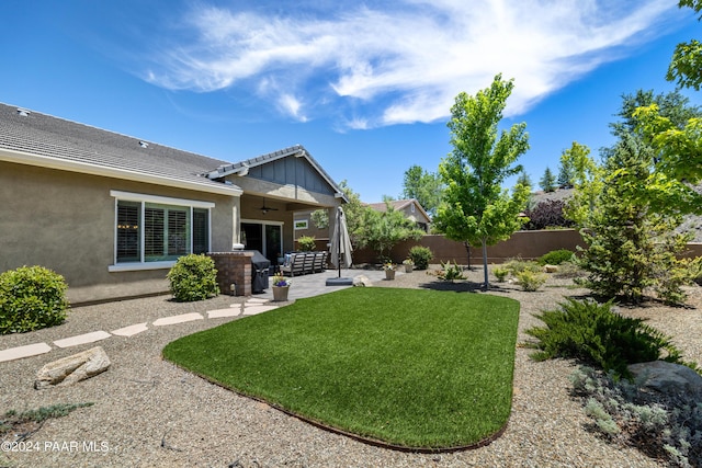 view of yard with a patio area and ceiling fan