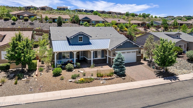 view of front of home featuring a porch and a garage