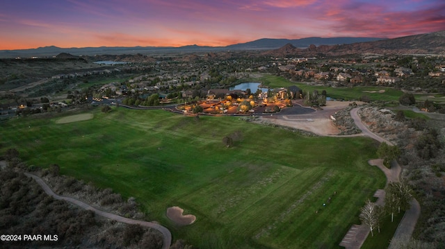 aerial view at dusk featuring a water and mountain view