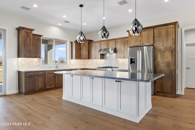 kitchen featuring a center island, light hardwood / wood-style floors, and appliances with stainless steel finishes