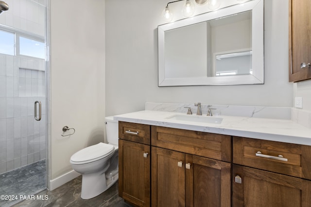 bathroom featuring vanity, toilet, and walk in shower