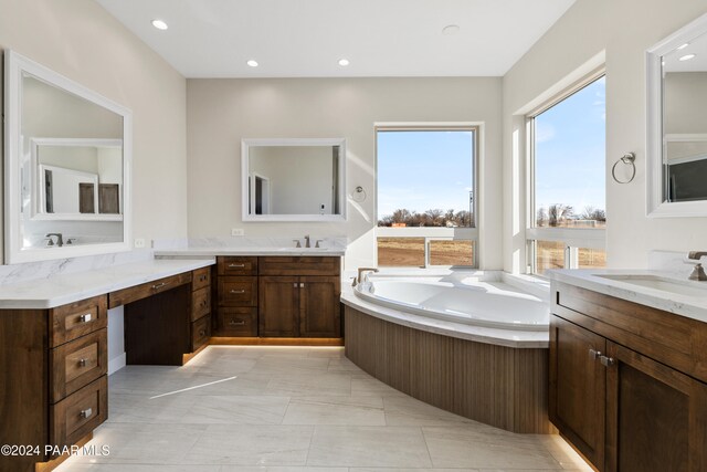 bathroom featuring a tub to relax in and vanity