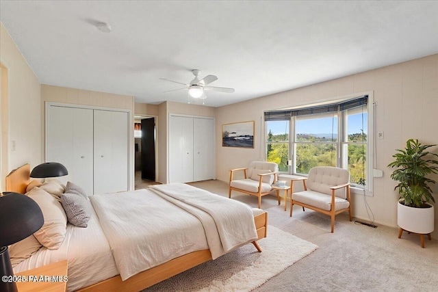 2403 Country Park Dr, Prescott, AZ 86305 - bedroom featuring two closets, ceiling fan, and light carpet