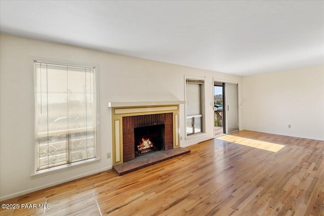 2403 Country Park Dr, Prescott, AZ 86305 - unfurnished living room featuring a brick fireplace and light wood-type flooring