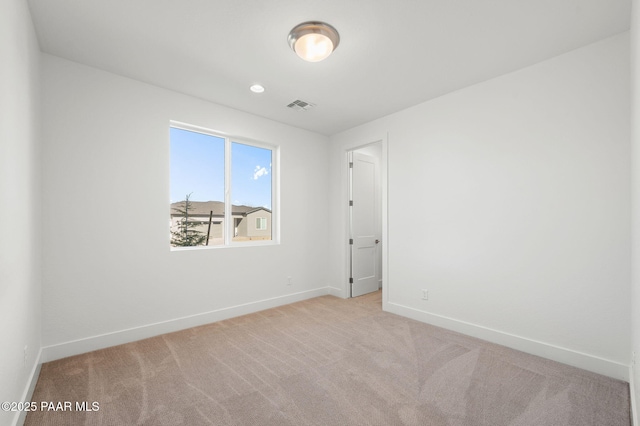 unfurnished room featuring light colored carpet