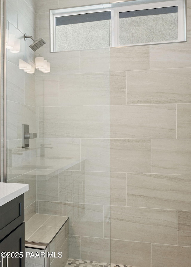 bathroom featuring vanity and a tile shower