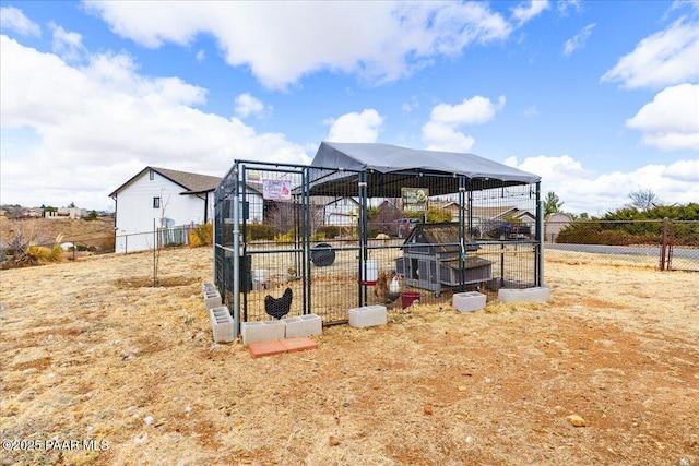 view of yard featuring exterior structure, fence, and an outdoor structure