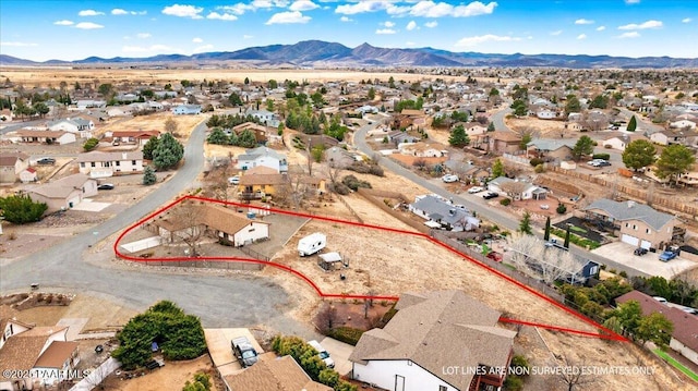 birds eye view of property with a residential view, a mountain view, and view of desert