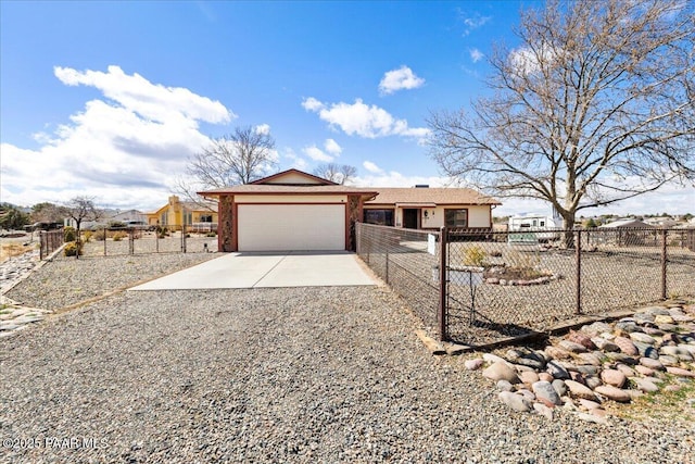 ranch-style home with concrete driveway, an attached garage, and fence