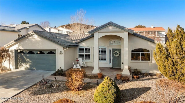 view of front of house featuring a porch and a garage