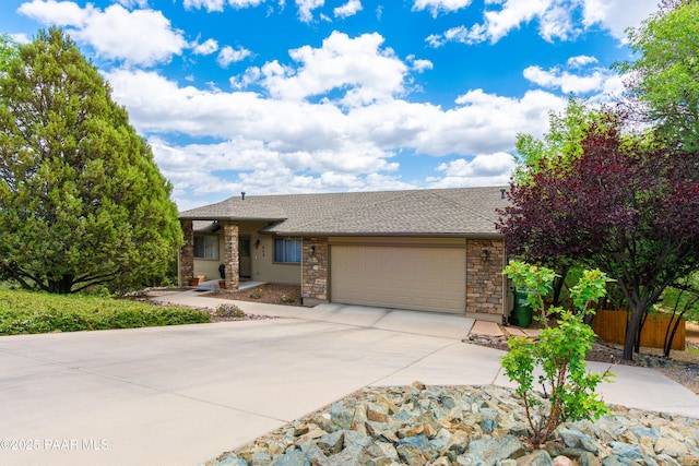 689 Frederick Ln, Prescott, AZ 86301 - view of front facade featuring concrete driveway, a garage, a shingled roof, and stone siding