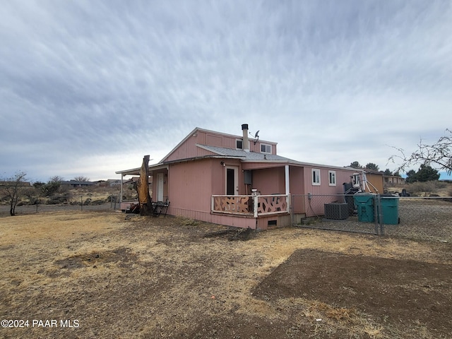 rear view of property featuring cooling unit