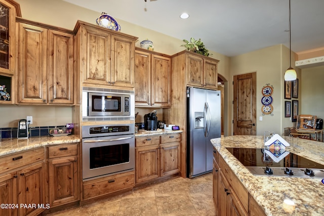 kitchen with appliances with stainless steel finishes, brown cabinets, decorative light fixtures, light stone countertops, and recessed lighting