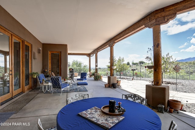 view of patio featuring outdoor dining area and a mountain view