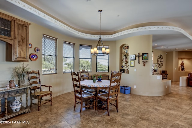 dining space with a chandelier, arched walkways, light tile patterned floors, and recessed lighting