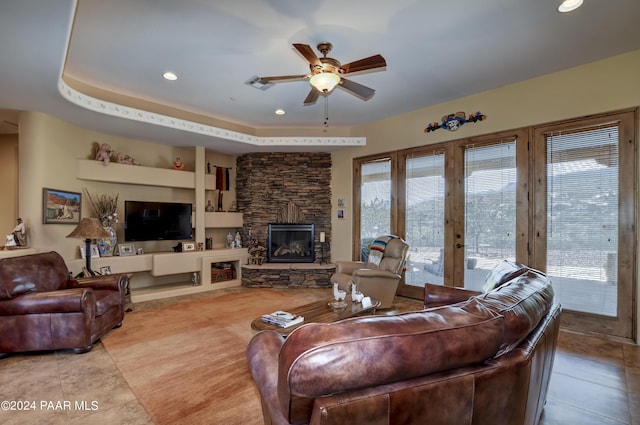 living area with ceiling fan, tile patterned flooring, a fireplace, recessed lighting, and built in features