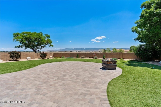 1915 N Bittersweet Way, Prescott Valley, AZ 86314 - fenced backyard with an outdoor fire pit, a patio area, and a mountain view