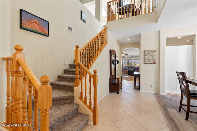 1915 N Bittersweet Way, Prescott Valley, AZ 86314 - stairway with arched walkways, tile patterned flooring, and recessed lighting