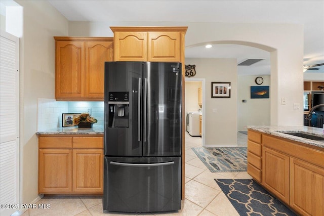 1915 N Bittersweet Way, Prescott Valley, AZ 86314 - kitchen with fridge with ice dispenser, arched walkways, light stone counters, light tile patterned floors, and backsplash